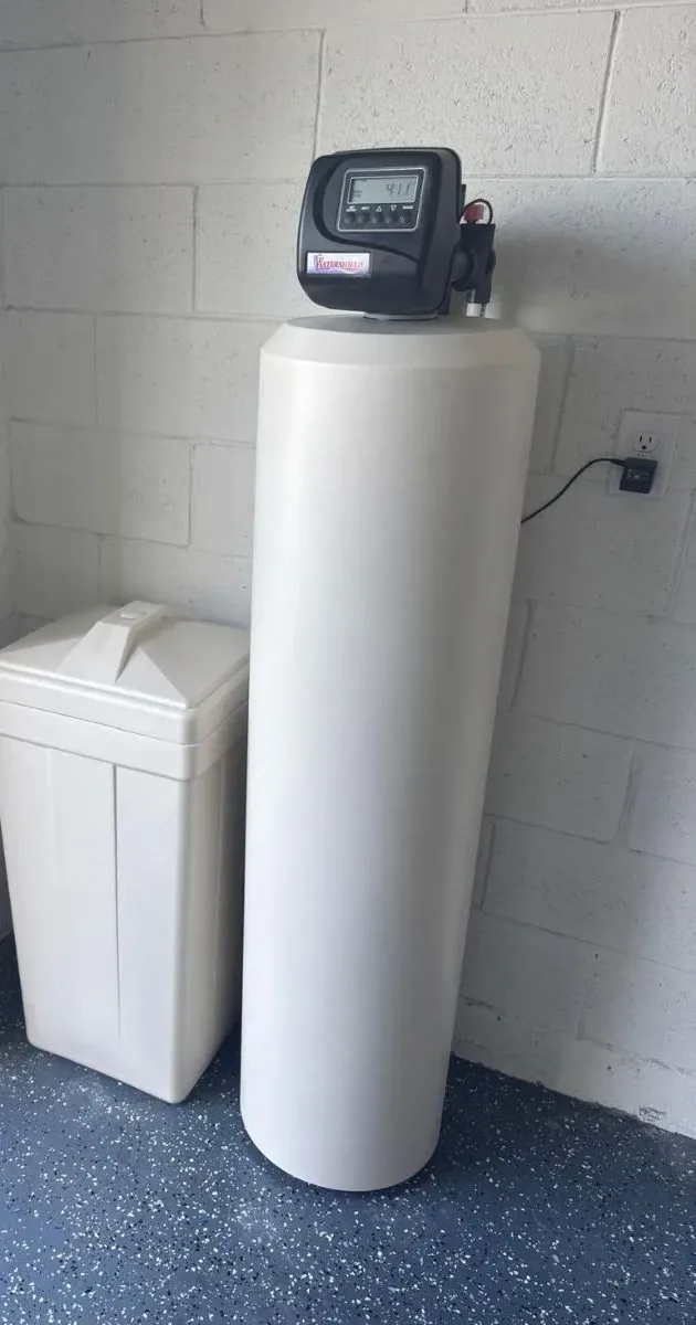 Whole-home water softener installed by Homery in a garage