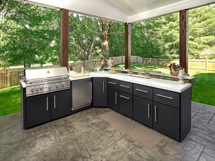 L-shaped outdoor kitchen with grill and bar counter